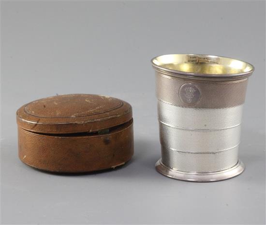 A cased Victorian engine turned silver travelling telescopic stirrup cup, by Robert Harper, retailed by Garrard & Co, diameter 77mm.